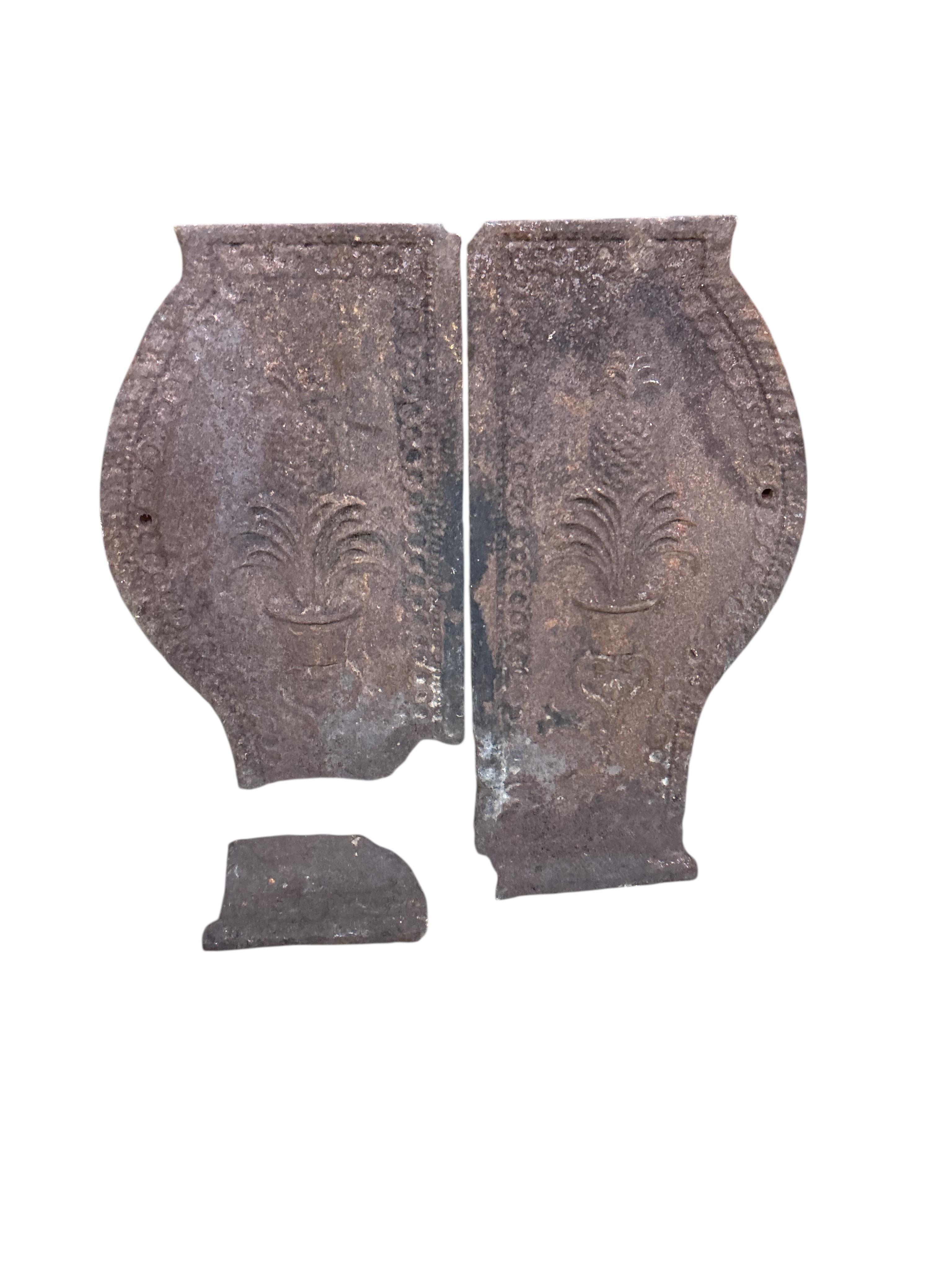 Three pairs of Victorian cast iron fire dogs and a fireback, damaged